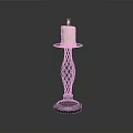 Lit Beige Candle On Decorative Braided Metal Candlestick Stand With Smooth Base