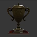 Golden Trophy With Curved Handles Lid And Red Transparent Base For Champion First Place