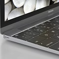Open Silver Laptop With Colorful Butterflies And White Pebbles Screen Display Alongside Closed Laptop