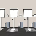 Three Modern Toilets With Water Tanks And Toilet Brushes On Gray Floor