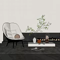 Modern White Accent Chair with Soft Cushions in Living Room with Green Plant and Fireplace