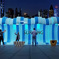 Surfing Themed Illuminated Wave Structure With People Taking Photos In Urban Night View