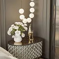Stylish Bedside Table With Black Tabletop White Vase Flowers And Golden Decor