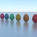 Six Colorful Sparkling Egg Shaped Decorative Ornament Set Arranged On Smooth Surface Against Blue Sky