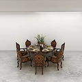 Round Wooden Dining Table With Ornate Upholstered Chairs And Floral Centerpiece In Minimalist Space