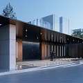 Modern Entrance Gate In Landscaped Area With Trees Benches And Paved Walkway