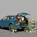 Blue SUV With Open Trunk Carrying Plants And Boxes Near Wooden Plant Stand
