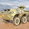 Military Camouflage Armored Vehicle With Six Wheels And Weapon Turret In Desert Terrain