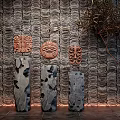 Decorative Ornament Combination on Textured Wall Featuring Carved Masks and Hollow-out Decorative Pieces