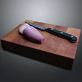 Sliced Purple Onion On Wooden Cutting Board With Black Handle Knife