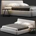 Modern Upholstered Double Bed With Gray Striped Quilt White Pillows And Small Round Side Tables