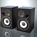 Pair of Black Bookshelf Speakers With Modern Design Round Speaker Drivers And Reflective Base