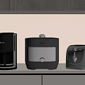 Modern Black And Gray Kitchen Appliances On Countertop Including Coffee Maker Pressure Cooker And Toaster