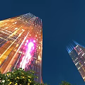 Illuminated Tall Glass Buildings Against Dark Sky Urban Night Landscape View