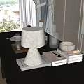 Cozy Tabletop Setup With White Lamp Books Glass Cup Tray Metal Container And Curtains