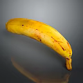 Ripe Yellow Banana with Brown Spots on Gray Background and Reflection