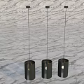 Three Modern Black Cylindrical Chandeliers Hanging In Interior With Marble Background