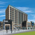 Modern Commercial Street Featuring High Rise Building Retail Shops And Green Lawn