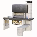 Stone Outdoor Cooking Station With Black Countertop Firewood And Cooking Utensils