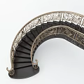 Elegant Spiral Staircase With Ornate Golden Railings And Black Steps