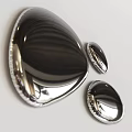Three Shiny Metallic Shell Shaped Objects With Polished Reflective Surface On White Background