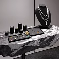 Elegant Black Rock Display Shelf Showcasing Layered Necklace And Small Jewelry Boxes