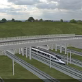 High Speed Train Passing Under Concrete Railway Viaduct With Green Landscape