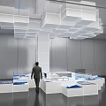 Modern Exhibition Hall With White Cube Installation Hanging From Ceiling And Blue Display Areas