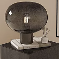 Black Round Glass Shade Table Lamp on Stacked Books with Aromatherapy Sticks