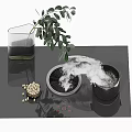 Modern Electric Cooktop with Steam Rising from Pot Glass Pitcher Green Plant and Scattered Nuts
