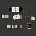 Various Colored Electronic E Readers in Different Sizes Open and Stacked on Gray Background