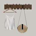 Wooden Wall Mounted Hooks Holding Striped Tank Top And Woven Round Bag