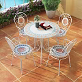 Wrought Iron Outdoor Table with Four Chairs on Patio Tile Floor and City View