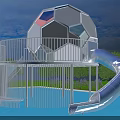 White Spherical Playground Equipment With Slides Stairs On Blue Ground Surrounded By Green Trees