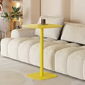 Modern Yellow Tea Table With A Cup Of Tea And Beige Sofa Nearby Green Plants