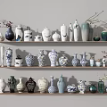 Various Decorative Vases In Different Styles And Colors On Shelves With Floral Branches