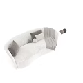 Two Seater Sofa In Neutral Tones With Round Square Pillows And Knitted Throw Blanket