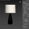 Modern Table Lamp With Linen Shade And Black Gold Base On Wooden Table