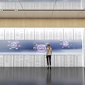 Person Interacting With Large Digital Screen Featuring Circular Icons On Wooden Wall