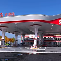 Red and White Canopy Gas Station with Fuel Pumps and Trees Around Vehicles Refueling