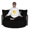 Woman Sitting Cross Legged On Black Leather Round Sofa Wearing White Top With Yellow Pattern