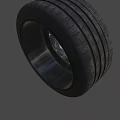 Black Car Wheel With Five Spoke Rim And Deep Tread Pattern 3d model