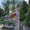 Building Exterior Wall Design Featuring Stone Steps Lush Greenery and Colorful Flowers
