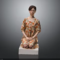 Child Sitting On White Block Wearing Floral Dress Against Gray Background