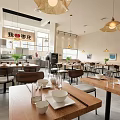 Modern Restaurant Interior With Dining Tables Chairs Pendant Lights And Open Kitchen