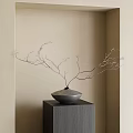 Gray Vase With Slender Branches On Gray Cubic Pedestal Against Beige Wall