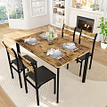 Warm Dining Room Setup With Wooden Table Black Chairs Tableware Flower Arrangement And Fireplace