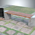 Outdoor Bench With Wooden Slat And Concrete Legs Near Trash Can On Stone Pavement