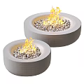 Two Round Modern Outdoor Concrete Fire Pits with Burning Flames and Decorative Pebbles