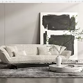 Beige Multi Seater Sofa With Cushions Black And White Abstract Painting And Round Coffee Table